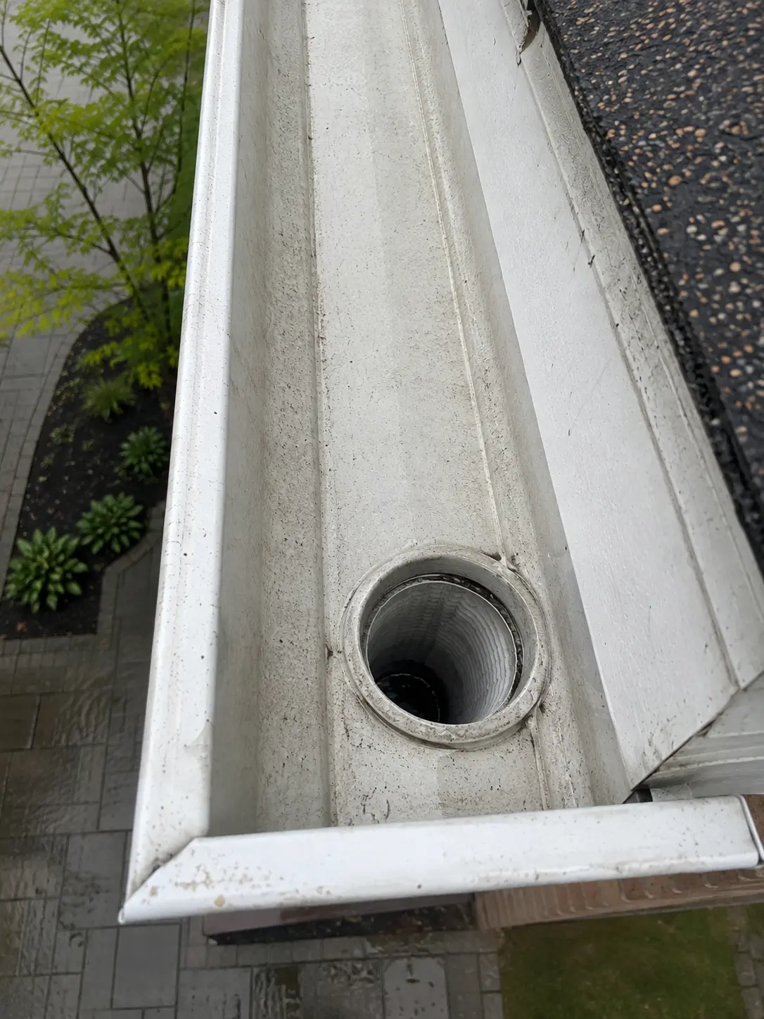 Clear eavestrough and open downspout outlet after cleaning